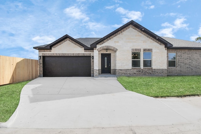 view of front facade with a garage and a front yard