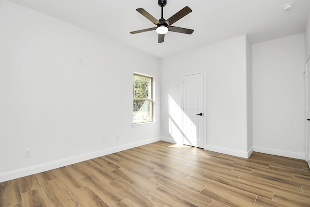 empty room featuring light wood-type flooring and ceiling fan