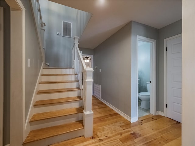 stairs with wood-type flooring