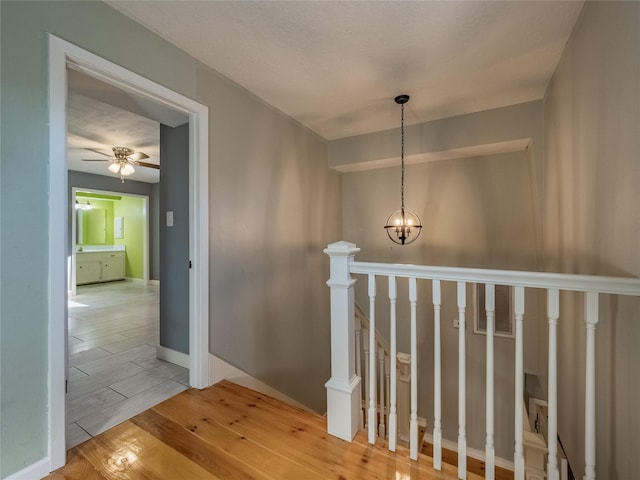 stairway featuring a chandelier