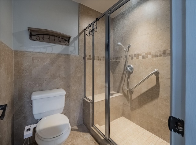 bathroom featuring tile patterned floors, toilet, and walk in shower