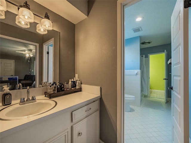 bathroom featuring tile patterned floors, ceiling fan, toilet, and vanity