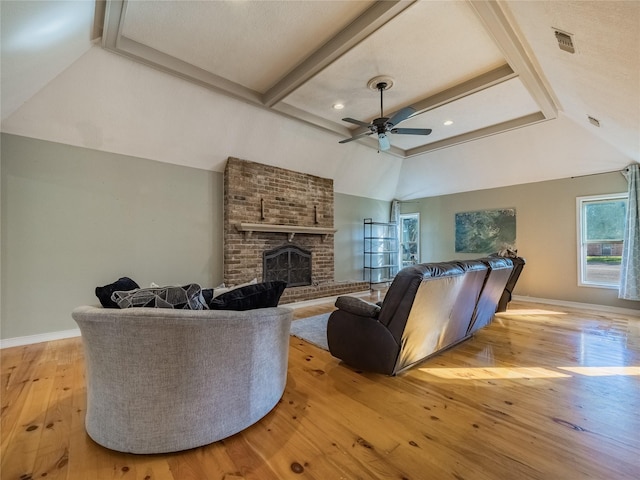 living room with ceiling fan, light hardwood / wood-style floors, and a brick fireplace