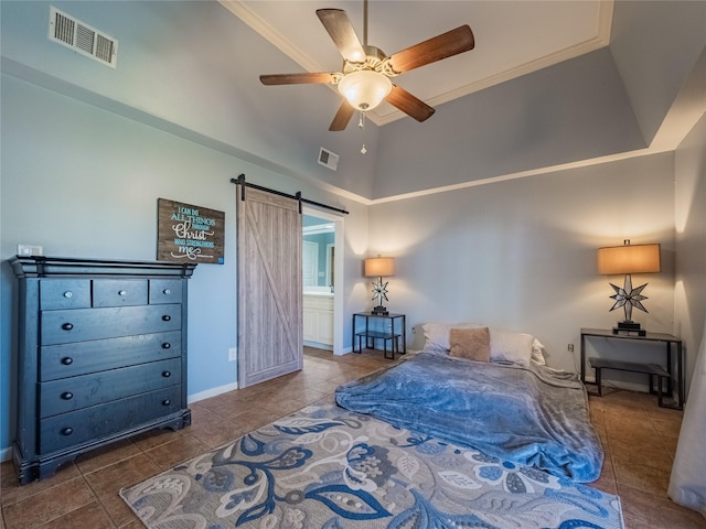 bedroom featuring ensuite bath, ceiling fan, a barn door, tile patterned flooring, and crown molding