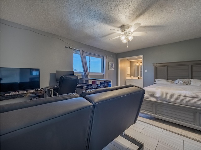 bedroom with ceiling fan and a textured ceiling