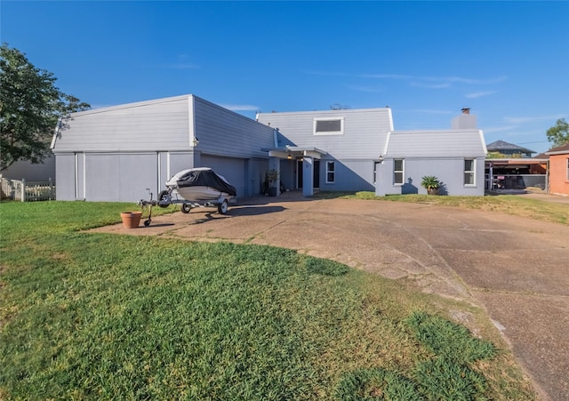 rear view of property featuring a lawn