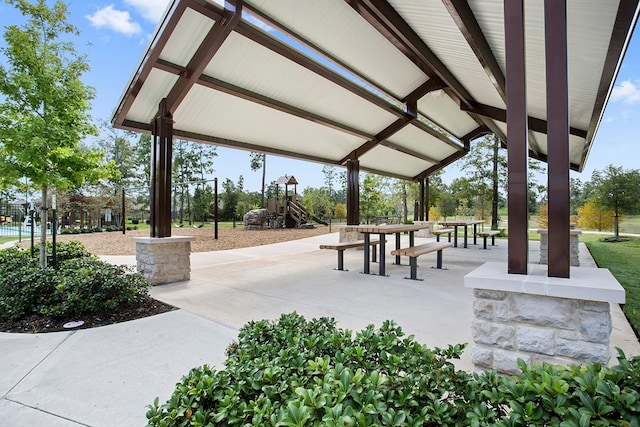 view of community featuring a playground and a patio area