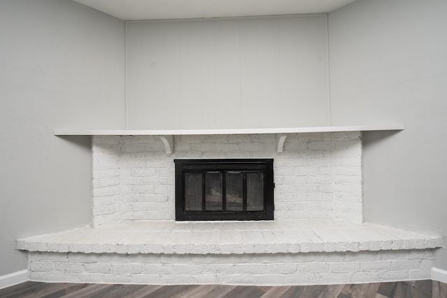 details with wood-type flooring and a fireplace