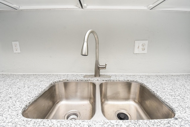 details featuring sink and light stone countertops