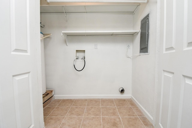 washroom with washer hookup, electric panel, hookup for an electric dryer, and light tile patterned flooring