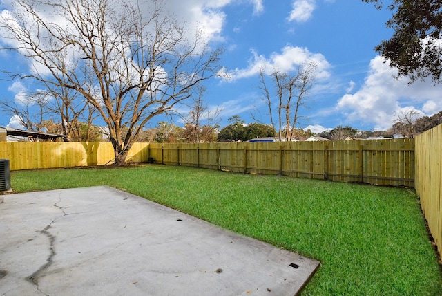 view of yard with a patio and central air condition unit