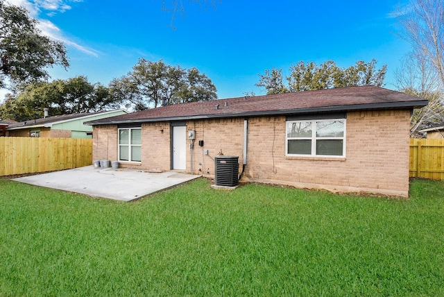 rear view of property featuring a patio, a yard, and central air condition unit