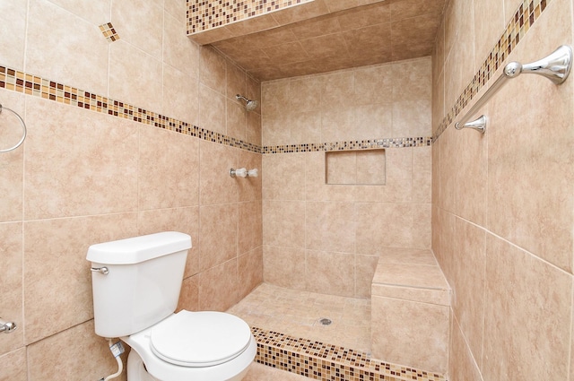 bathroom with toilet and a tile shower