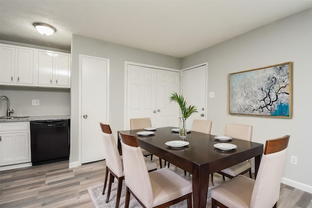 dining area with sink and hardwood / wood-style floors