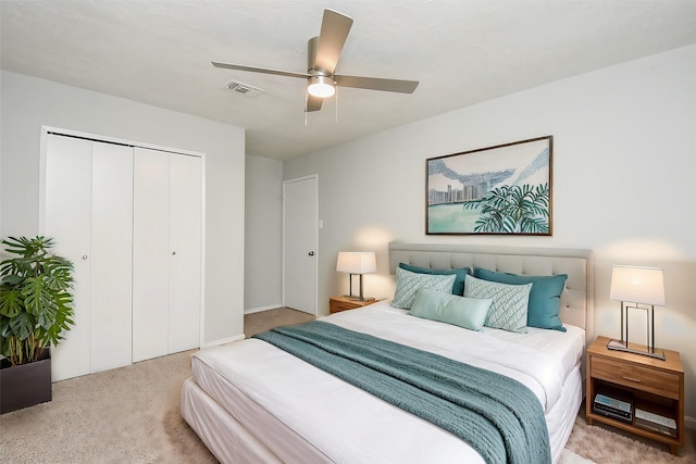 carpeted bedroom featuring ceiling fan and a closet