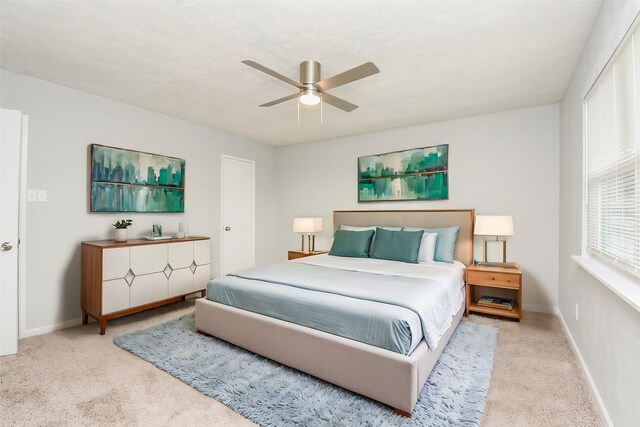 carpeted bedroom featuring ceiling fan