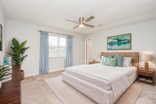 bedroom with light carpet and ceiling fan