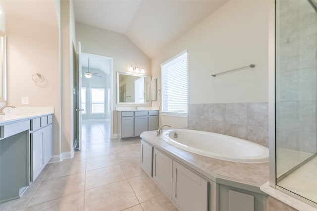 bathroom with tile patterned floors, a bathtub, vanity, vaulted ceiling, and ceiling fan