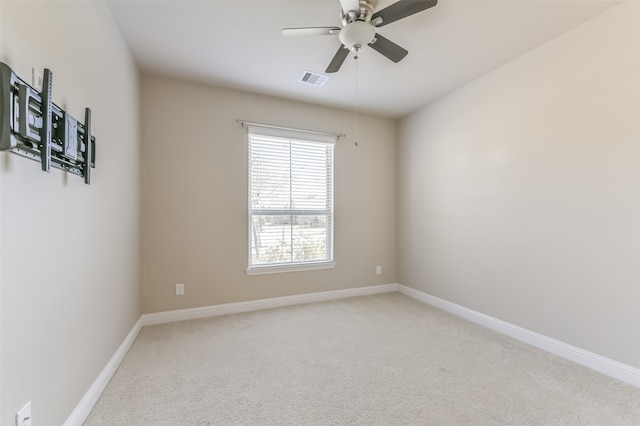 carpeted spare room featuring ceiling fan