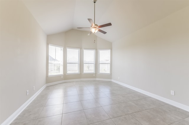 spare room featuring ceiling fan, light tile patterned flooring, and lofted ceiling