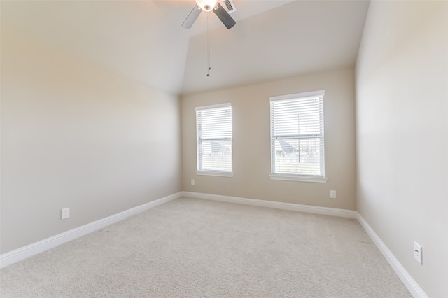 carpeted spare room with ceiling fan and lofted ceiling