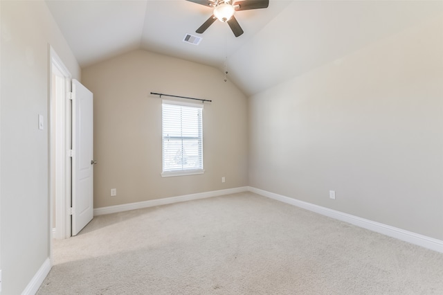 interior space with ceiling fan, light colored carpet, and lofted ceiling