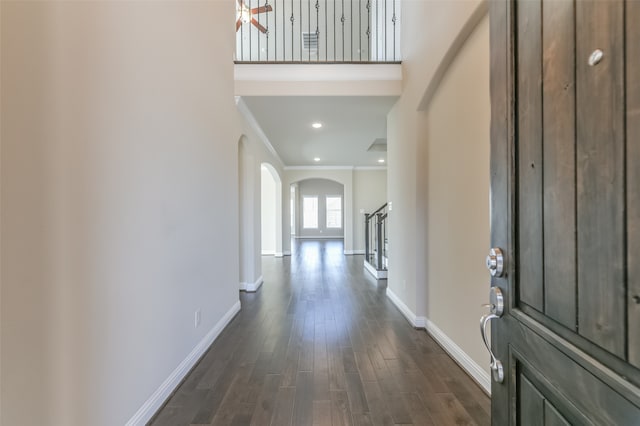 foyer with dark hardwood / wood-style flooring and crown molding