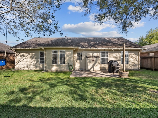 rear view of house featuring a yard and a patio