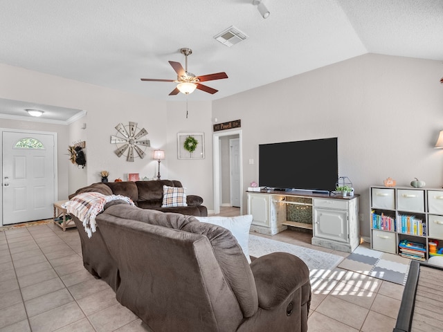 living room featuring ceiling fan, lofted ceiling, and light tile patterned flooring