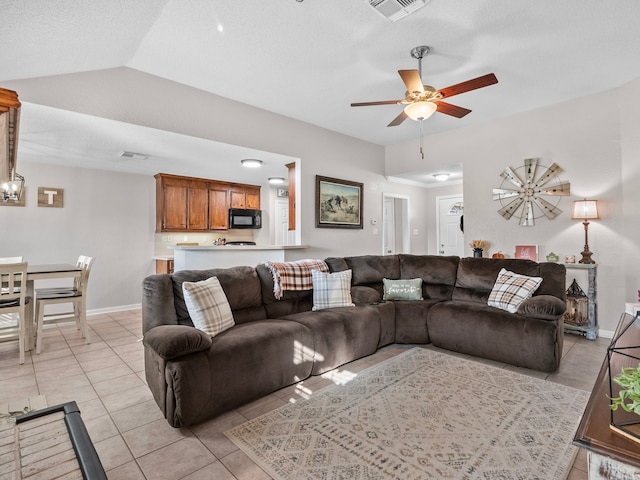 living room featuring light tile patterned floors, ceiling fan, and lofted ceiling