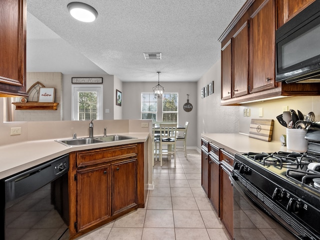 kitchen featuring sink, an inviting chandelier, decorative light fixtures, light tile patterned flooring, and black appliances