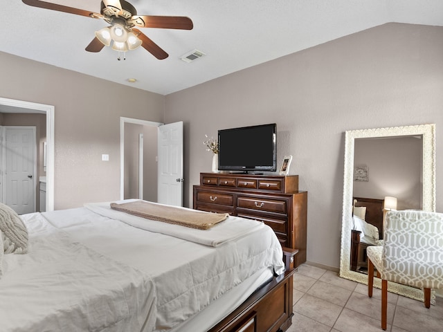 bedroom featuring ceiling fan, light tile patterned flooring, and lofted ceiling