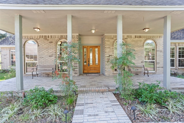 view of exterior entry with covered porch