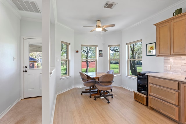 dining space with ceiling fan, light hardwood / wood-style floors, crown molding, and a wealth of natural light