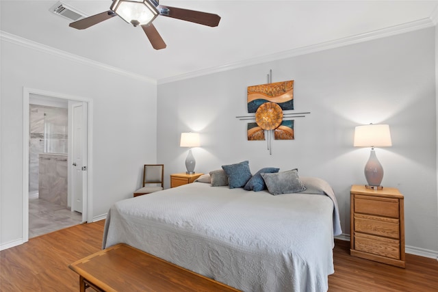 bedroom featuring wood-type flooring, ensuite bath, ceiling fan, and crown molding