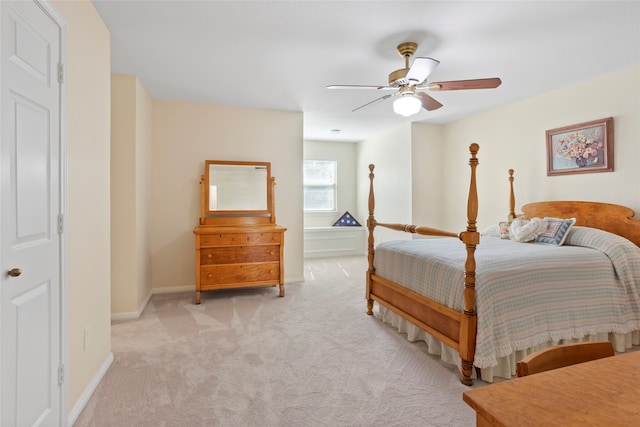 bedroom featuring ceiling fan and light colored carpet