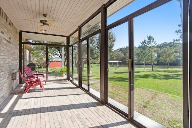 unfurnished sunroom featuring ceiling fan and wooden ceiling