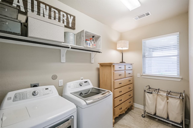 clothes washing area with washer and clothes dryer