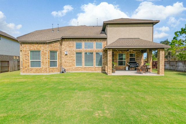 back of house featuring a yard, ceiling fan, and a patio area