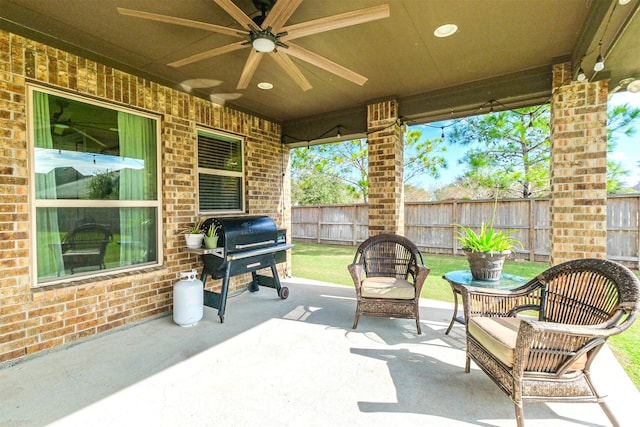 view of patio with area for grilling and ceiling fan