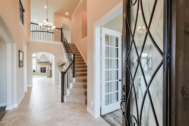 entryway with a fireplace and an inviting chandelier