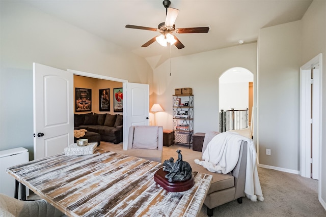 carpeted bedroom with ceiling fan and vaulted ceiling