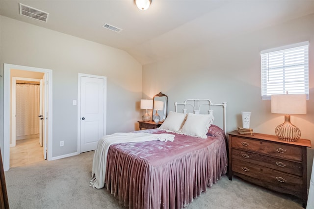 carpeted bedroom featuring vaulted ceiling