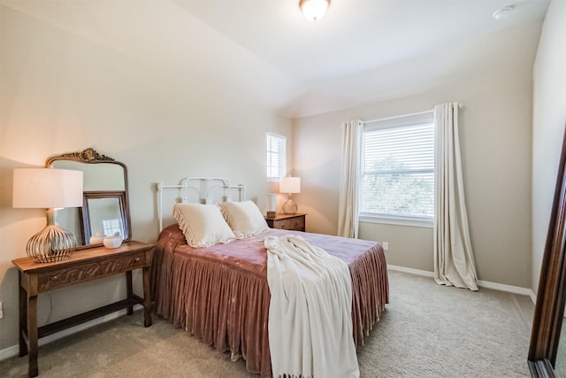 carpeted bedroom featuring lofted ceiling