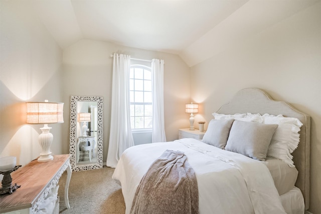 bedroom with light colored carpet and vaulted ceiling