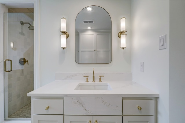 bathroom with vanity and a shower with shower door