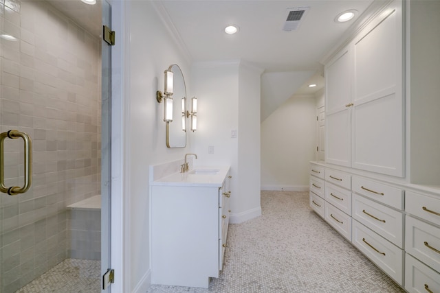 bathroom with vanity, an enclosed shower, and crown molding