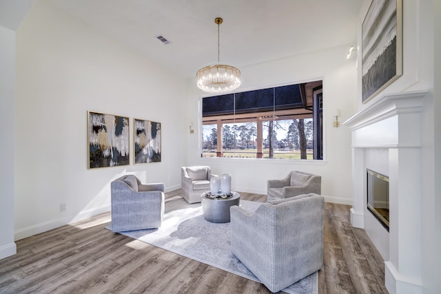 living room with wood-type flooring and a chandelier