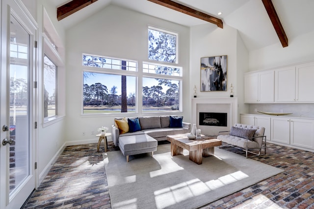 living room featuring beam ceiling and high vaulted ceiling