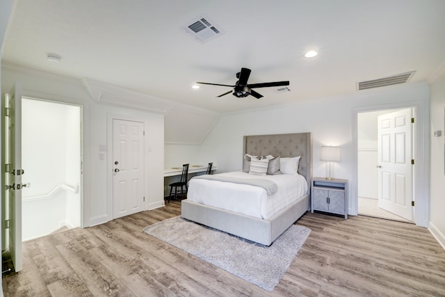 bedroom featuring ceiling fan, crown molding, and light hardwood / wood-style floors